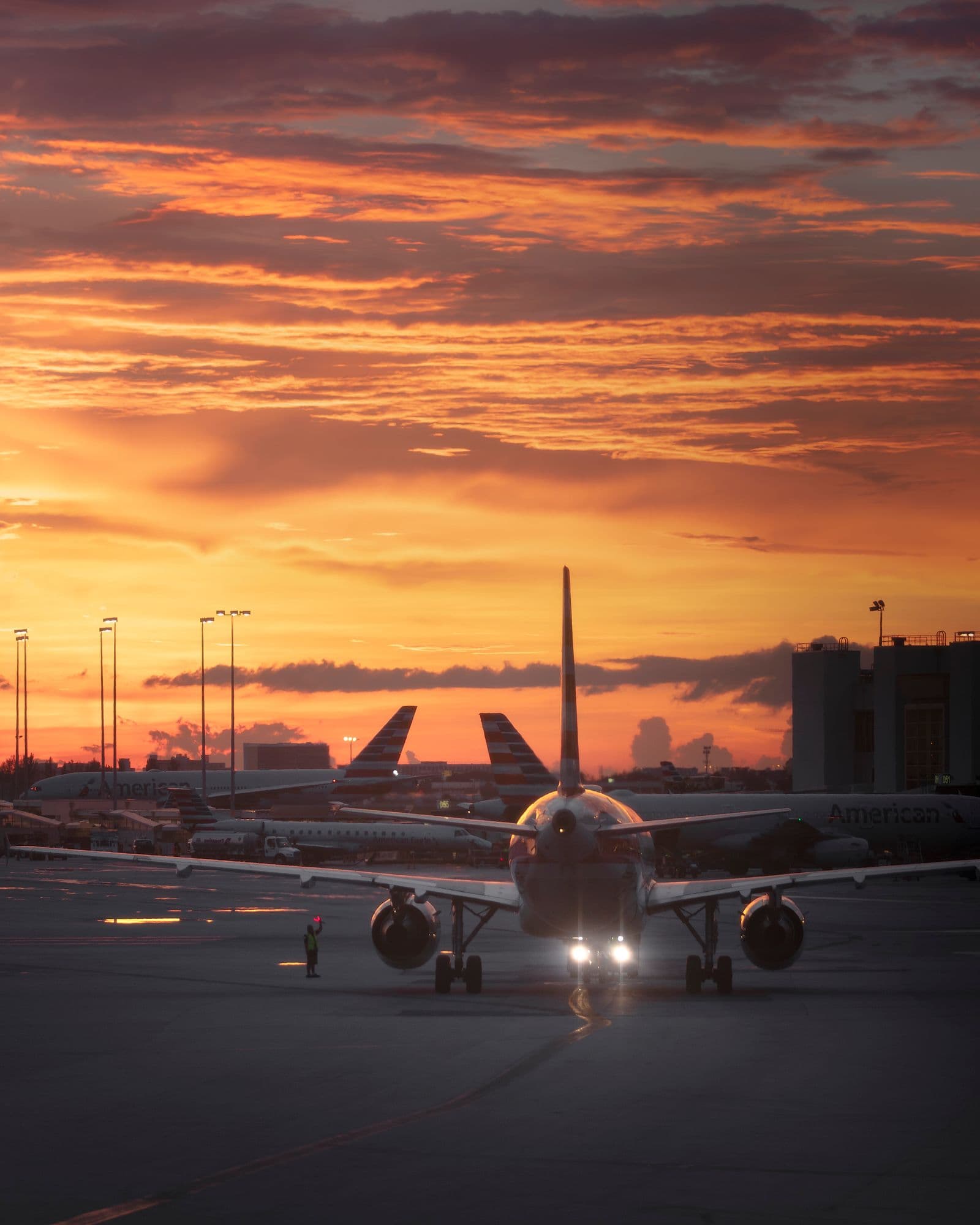 Aircraft moving on the apron at sunset
